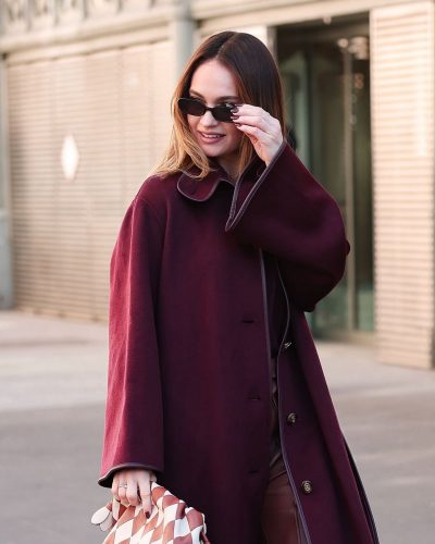 Lily James in tailored leather trousers and maroon blouse