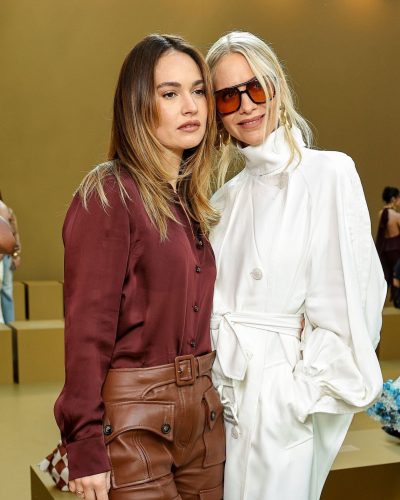 Lily James in maroon blouse paired with leather trousers