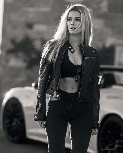 Lindsay Brewer in a sleek burgundy dress that complements her features.