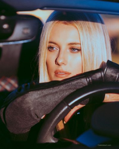 Lindsay Brewer in a chic burgundy dress that flatters her figure.