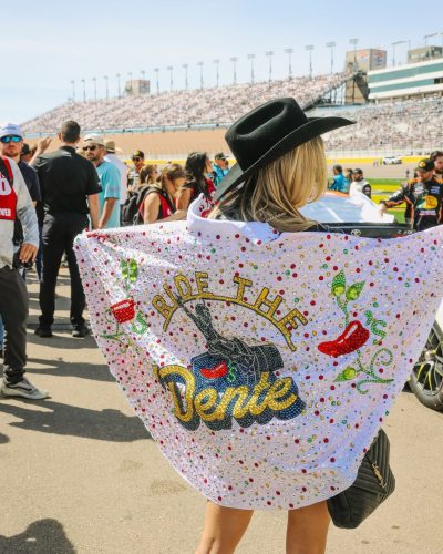 Lindsay Brewer wearing a bold burgundy gown with fitted silhouette.