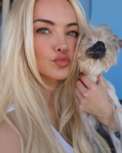 Lindsey Pelas wearing black blazer over animal print swimwear