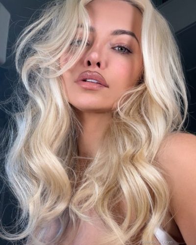 Lindsey Pelas wearing black blazer over animal print swimwear