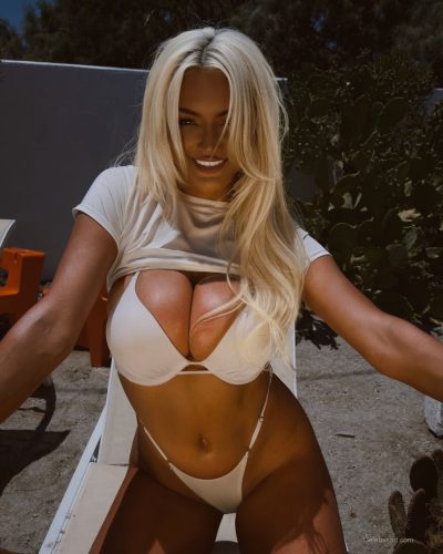 Lindsey Pelas in chic black blazer paired with animal print