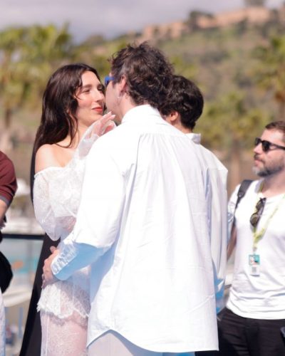 Lola Rodriguez in fitted white dress with intricate lace design