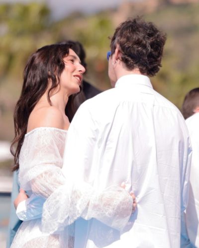 Lola Rodriguez in white lace dress with flowing silhouette
