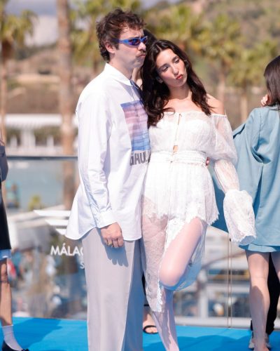 Lola Rodriguez in elegant white dress with romantic lace elements