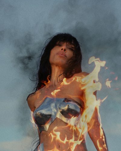 Loreen cropped metallic top in silver paired with sleek bottoms.