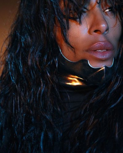 Loreen midriff-baring metallic top in silver with sleek bottoms.