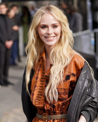 Loreto Peralta in contemporary brown dress with black bomber