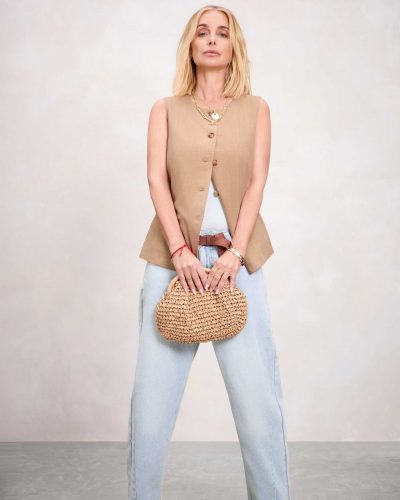 Louise Redknapp featuring a brown shirt and elegant cream pants.