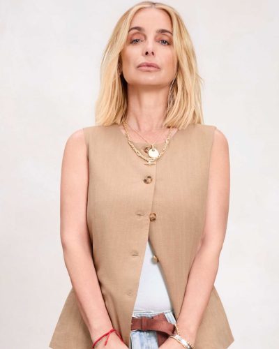 Louise Redknapp wearing a stylish brown shirt with cream trousers.