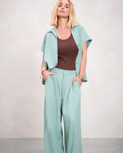 Louise Redknapp in a brown shirt and tailored cream trousers.