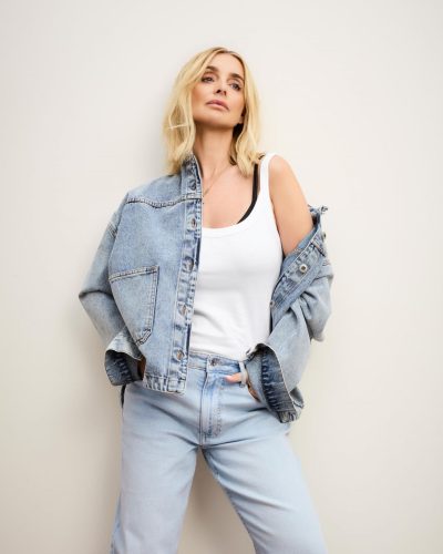 Louise Redknapp in brown belted shirt and cream trousers.