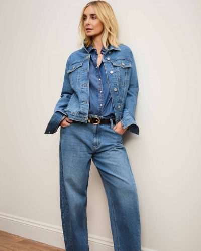 Louise Redknapp featuring a brown shirt and elegant cream pants.