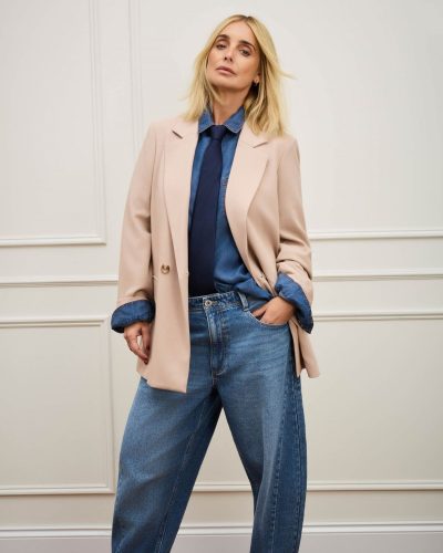 Louise Redknapp wearing a stylish brown shirt with cream trousers.