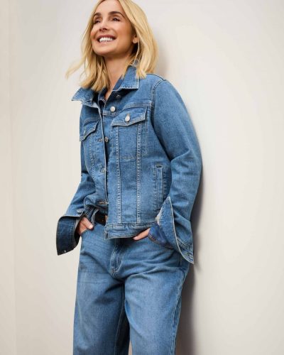 Louise Redknapp in a brown shirt paired with cream trousers.