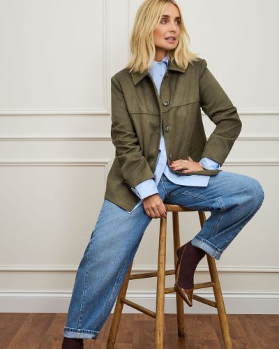Louise Redknapp featuring a brown shirt and elegant cream pants.