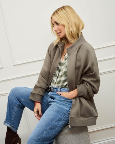 Louise Redknapp wearing a stylish brown shirt with cream trousers.