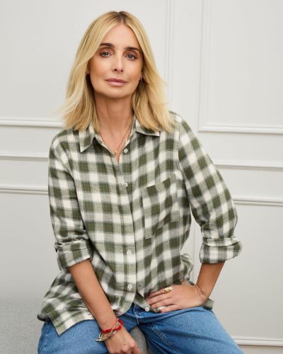 Louise Redknapp in a brown shirt paired with cream trousers.