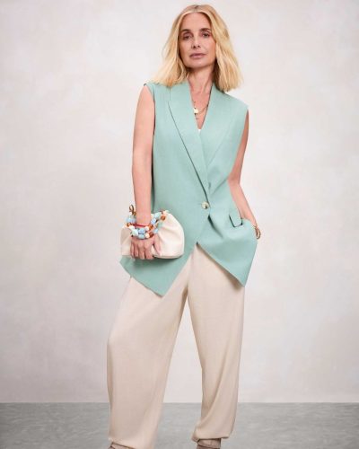 Louise Redknapp in brown belted shirt and cream trousers.