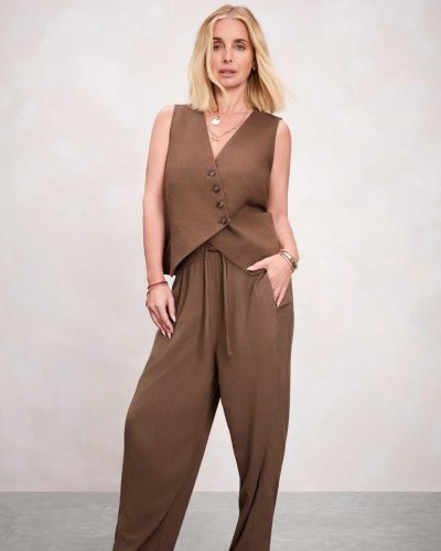 Louise Redknapp in a relaxed brown shirt and cream trousers.