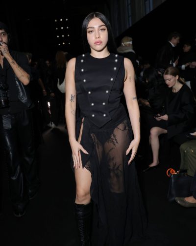 Lourdes Leon in black top with silver buttons and flowing skirt