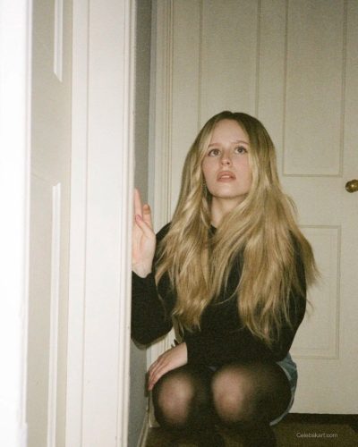 Lulu Wilson dressed in black top and fashionable denim shorts.