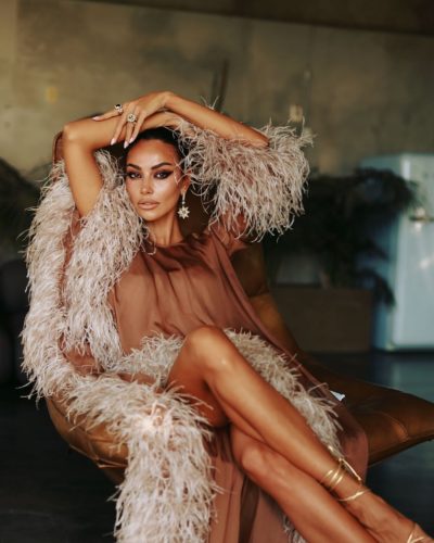 Madalina Ghenea stylish brown gown with whimsical feather accents