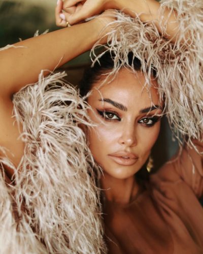 Madalina Ghenea graceful brown dress with striking feather features