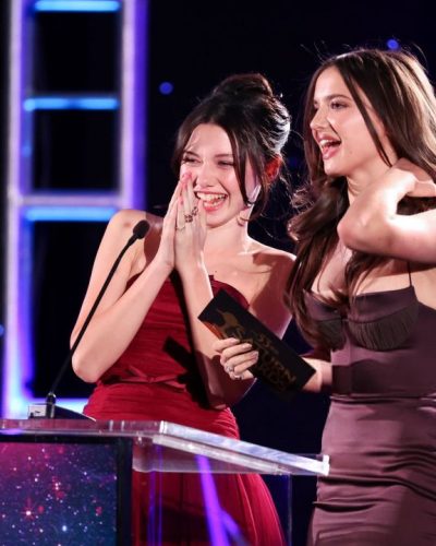 Madeleine McGraw burgundy dress accentuating her figure and warm complexion