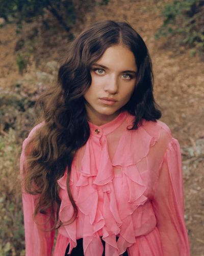 Madeleine McGraw in pink ruffled dress paired with stylish footwear