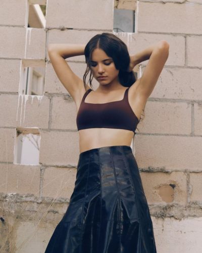 Madeleine McGraw in pink ruffled dress with dark belt