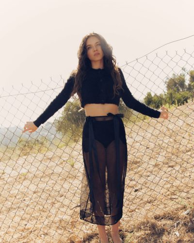 Madeleine McGraw in pale pink blouse and stylish fitted skirt