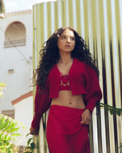 Madeleine McGraw with delicate flower and pink ruffled blouse