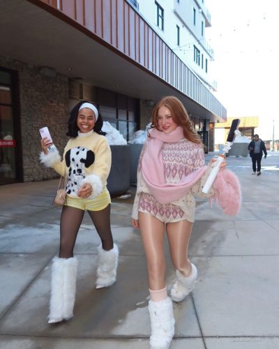 Madeline Ford with colorful sweater and cozy winter boots.