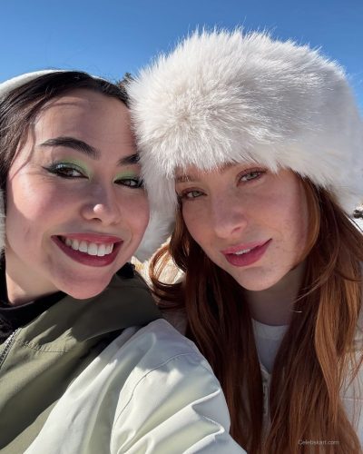 Madeline Ford with colorful sweater and cozy winter boots.