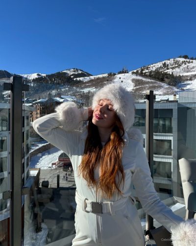 Madeline Ford wearing light pink sweater and trendy winter footwear.