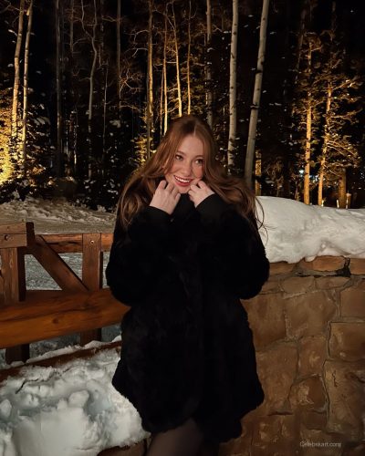 Madeline Ford in bright pink sweater and comfortable fluffy boots.