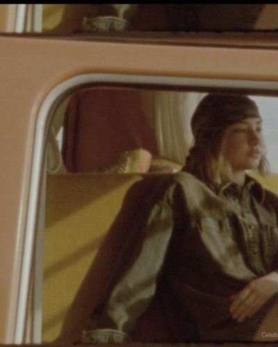 Madelyn Cline styled with a red shirt and stylish white shorts.