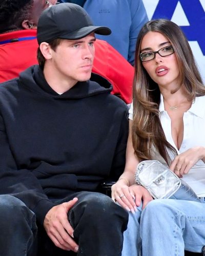 Madison Beer with a white fitted top and stylish blue jeans.