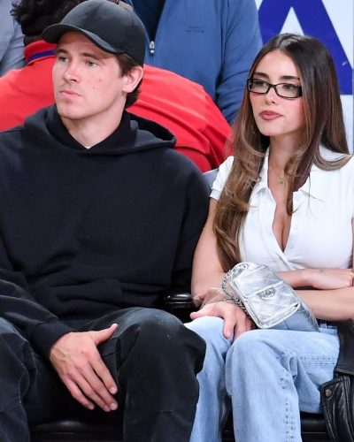 Madison Beer sporting a white button-up and casual blue denim.