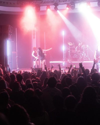 Maggie Lindemann wearing black dress with bold studded accents.