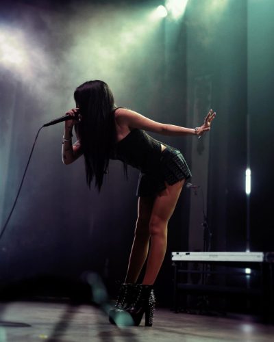 Maggie Lindemann wearing black high-heeled boots with spikes.