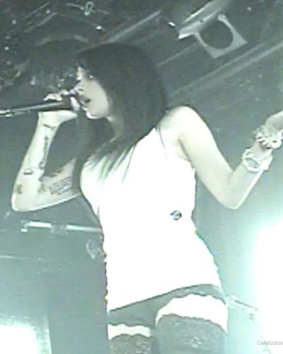 Maggie Lindemann with lace stockings and white tank top