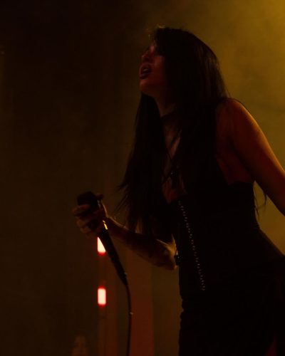 Maggie Lindemann wearing a fitted black gown with edgy accessories.