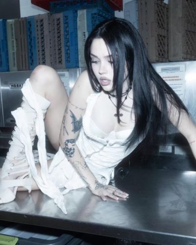 Maggie Lindemann in satin white dress emphasizing her figure.