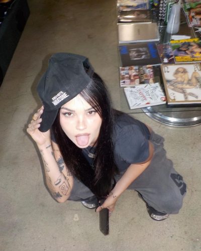 Maggie Lindemann wearing chunky platform sneakers and black t-shirt.