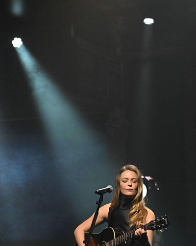 Maggie Rogers in black gown with minimal design and striking silhouette.