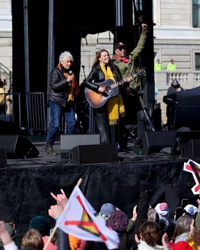 Maggie Rogers black leather jacket complemented by dark trousers